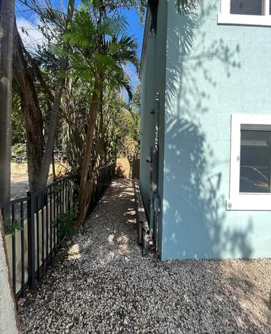 a view of a pathway of a house with a yard