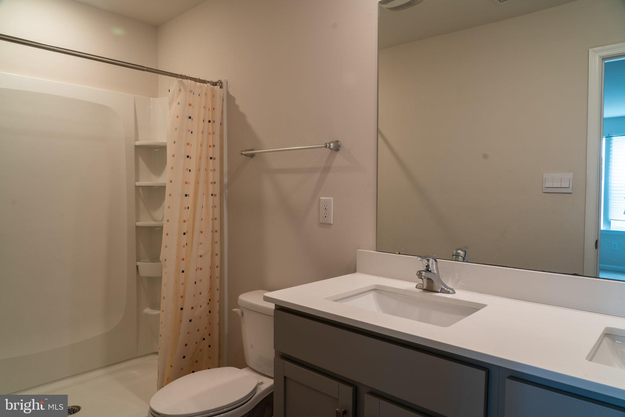 57 Arlotta Street Glassboro, NJ 08028 - Photo 11 of 17 a bathroom with a sink toilet and shower