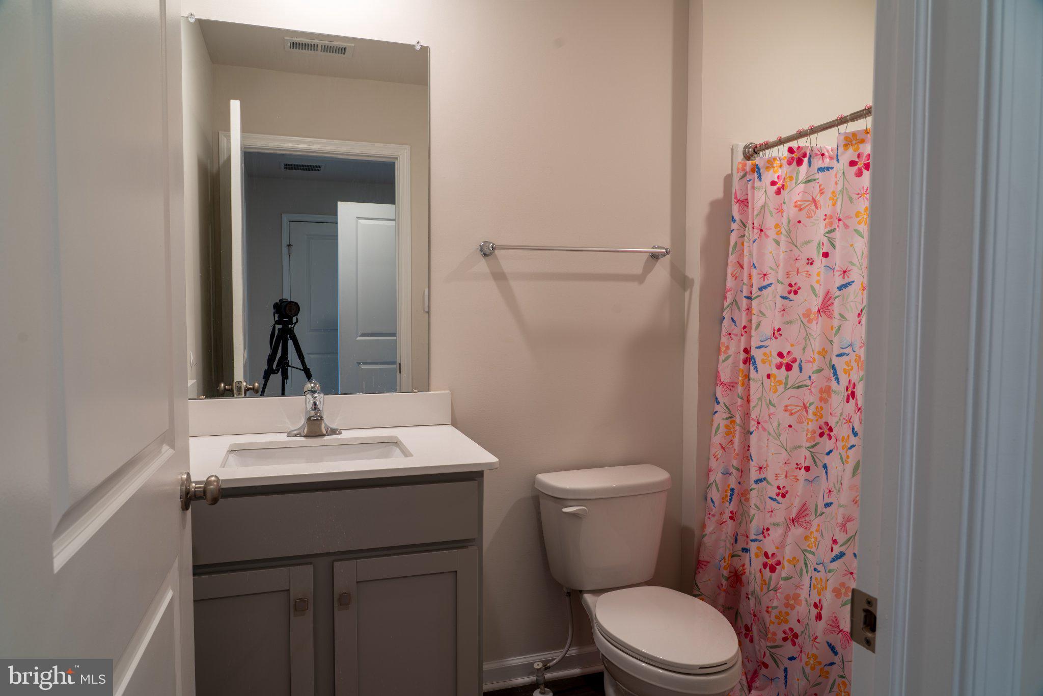 57 Arlotta Street Glassboro, NJ 08028 - Photo 15 of 17 a bathroom with a sink a toilet and shower curtain