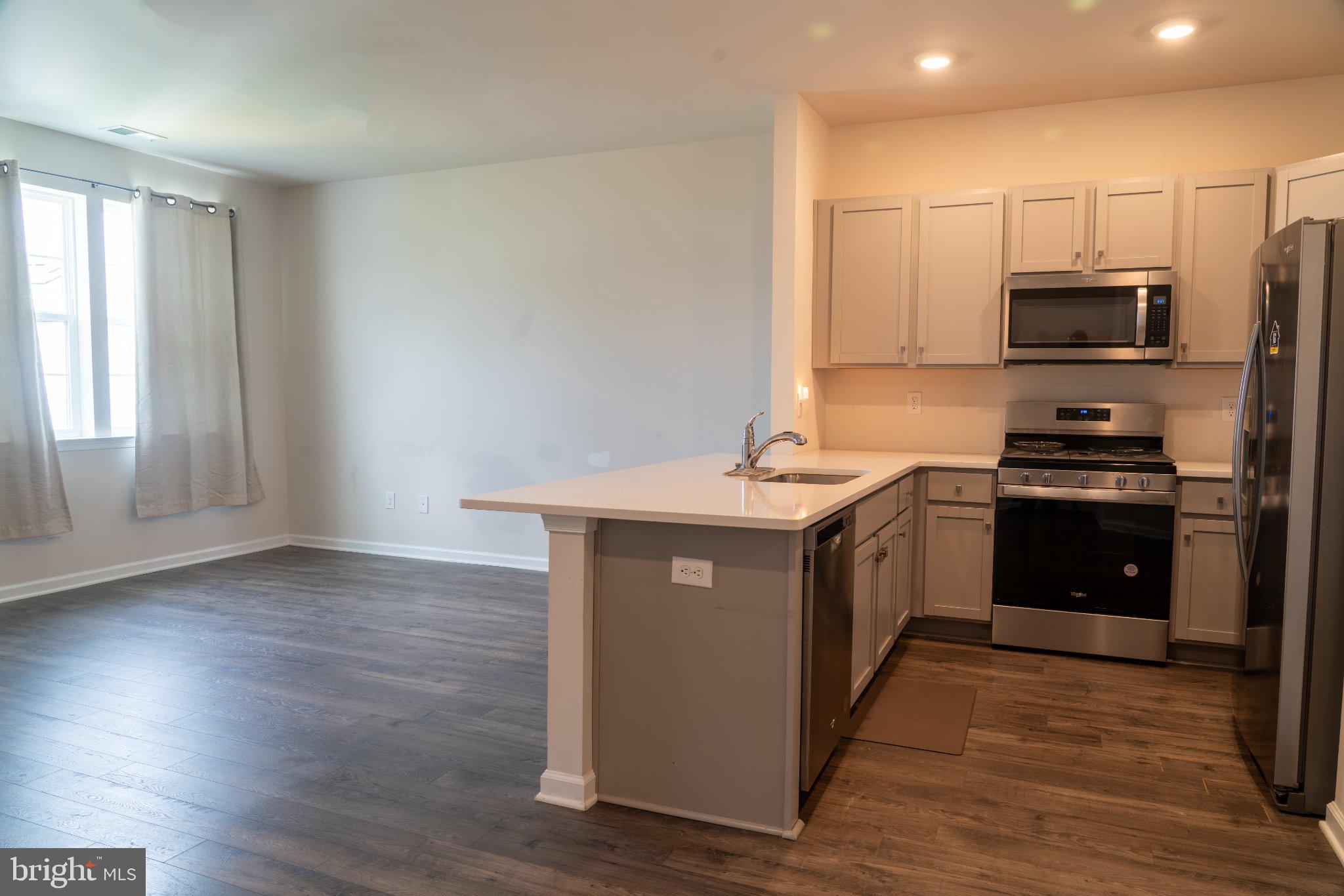 57 Arlotta Street Glassboro, NJ 08028 - Photo 4 of 17 a kitchen with stainless steel appliances a sink a stove a microwave and cabinets
