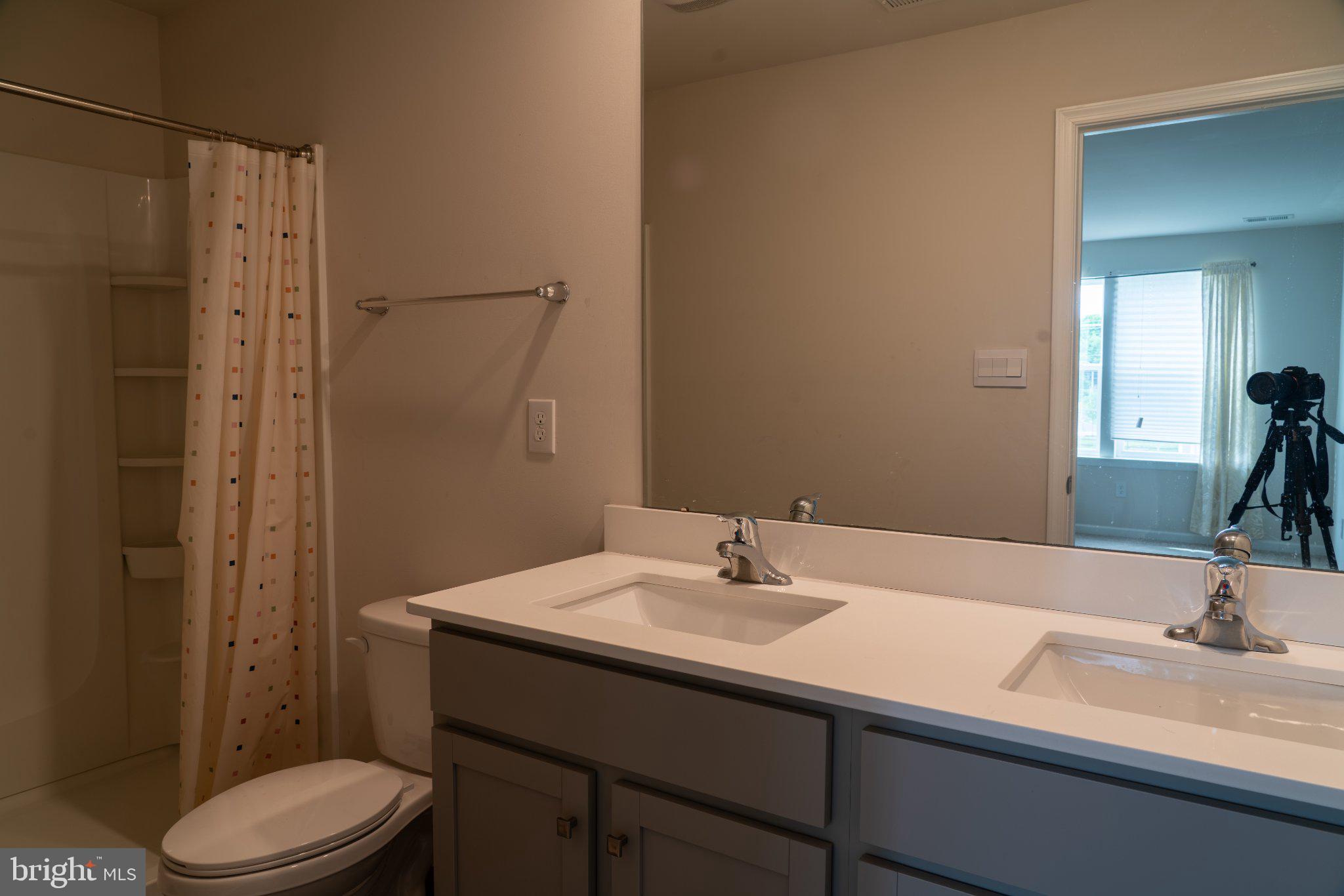 57 Arlotta Street Glassboro, NJ 08028 - Photo 10 of 17 a bathroom with a sink toilet and shower