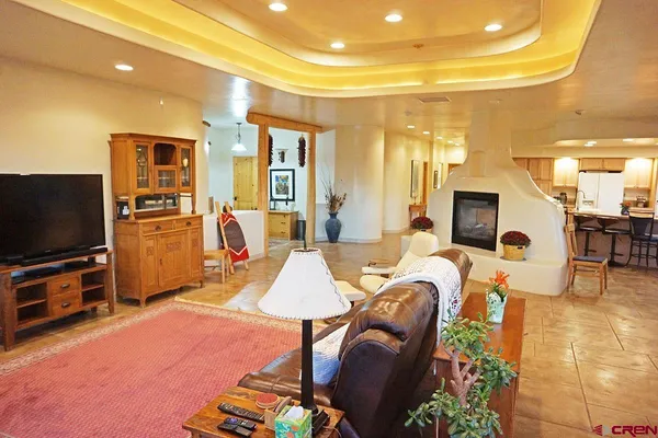 a living room filled with furniture and a floor to ceiling window