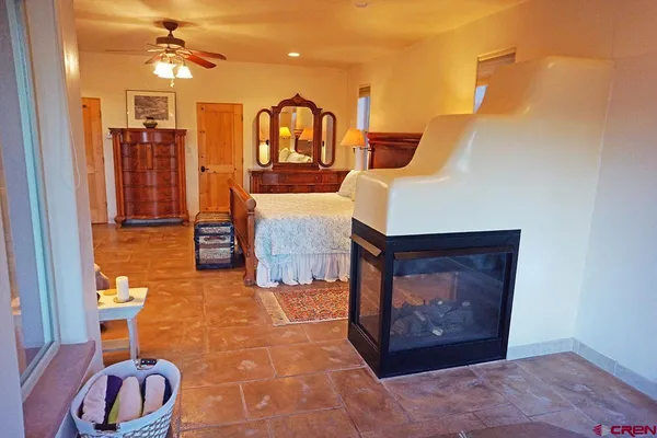 a kitchen with stainless steel appliances granite countertop a stove top oven a sink dishwasher and white cabinets with wooden floor