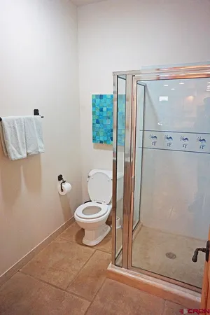 a bathroom with a sink mirror and a shower