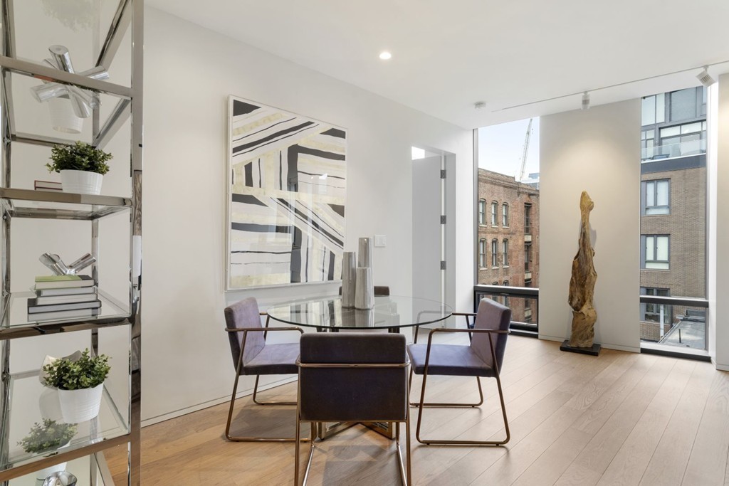 10 Farnsworth Street, Unit 5B Boston, MA 02210 - Photo 11 of 35 a view of a dining room with furniture and wooden floor