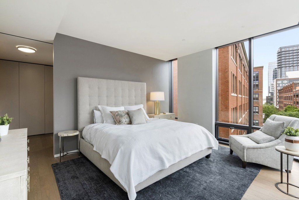 10 Farnsworth Street, Unit 5B Boston, MA 02210 - Photo 14 of 35 a bedroom with a bed and glass window