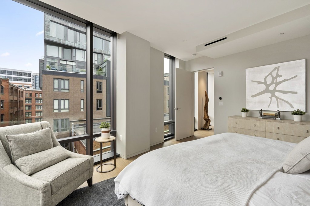 10 Farnsworth Street, Unit 5B Boston, MA 02210 - Photo 16 of 35 a bedroom with a large bed and a couch