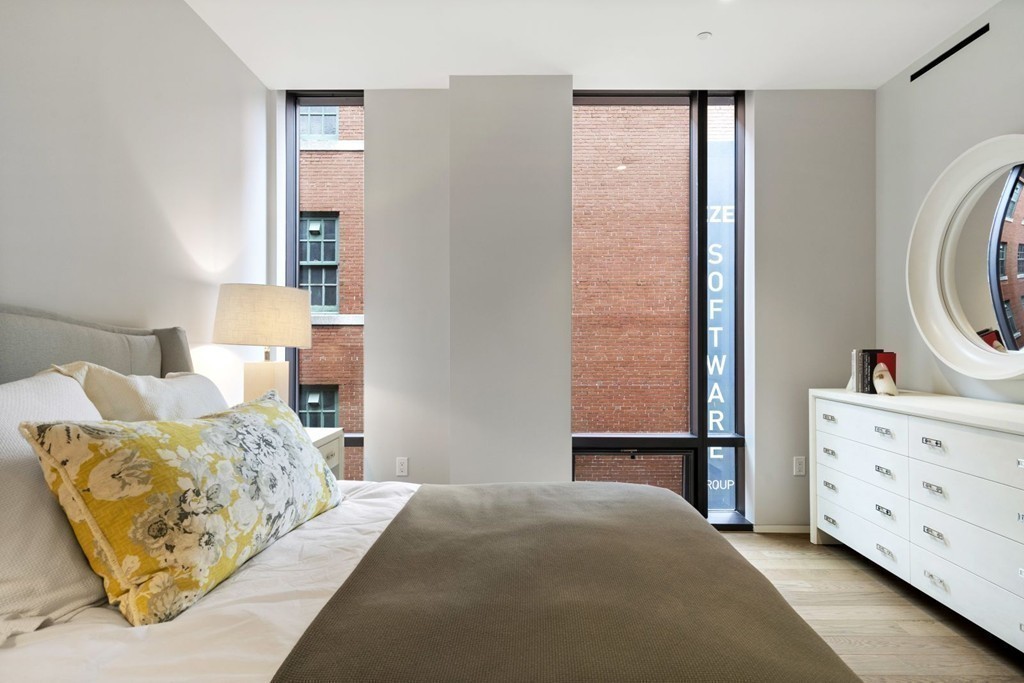 10 Farnsworth Street, Unit 5B Boston, MA 02210 - Photo 20 of 35 a bedroom with a bed and a dresser in it