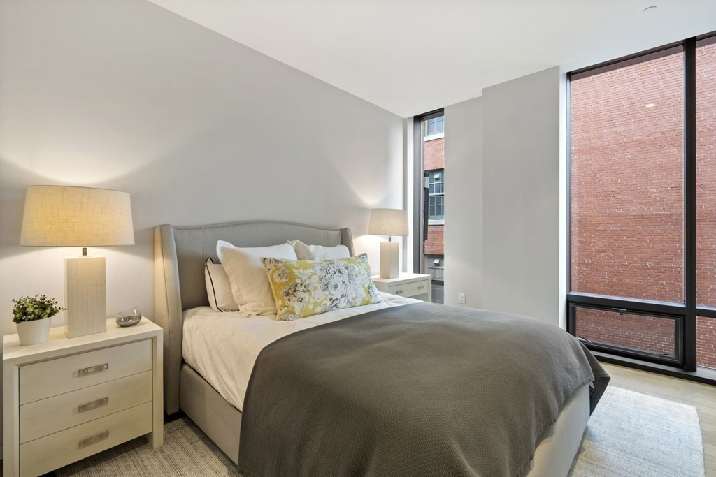 10 Farnsworth Street, Unit 5B Boston, MA 02210 - Photo 21 of 35 a bedroom with a bed and a lamp on the dresser