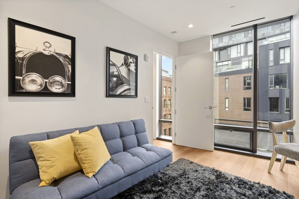 10 Farnsworth Street, Unit 5B Boston, MA 02210 - Photo 25 of 35 a living room with furniture and a painting on the wall