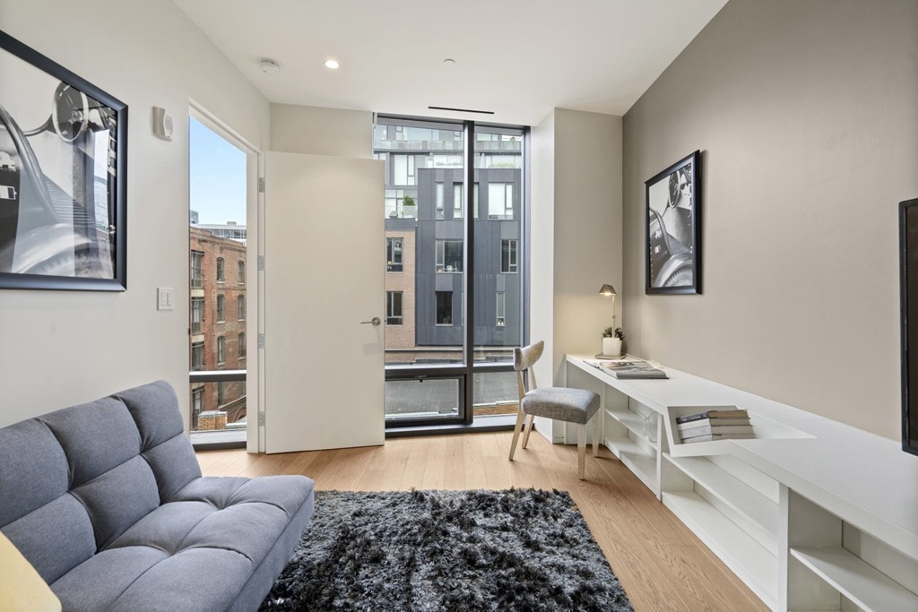 10 Farnsworth Street, Unit 5B Boston, MA 02210 - Photo 26 of 35 a living room with furniture and wooden floor