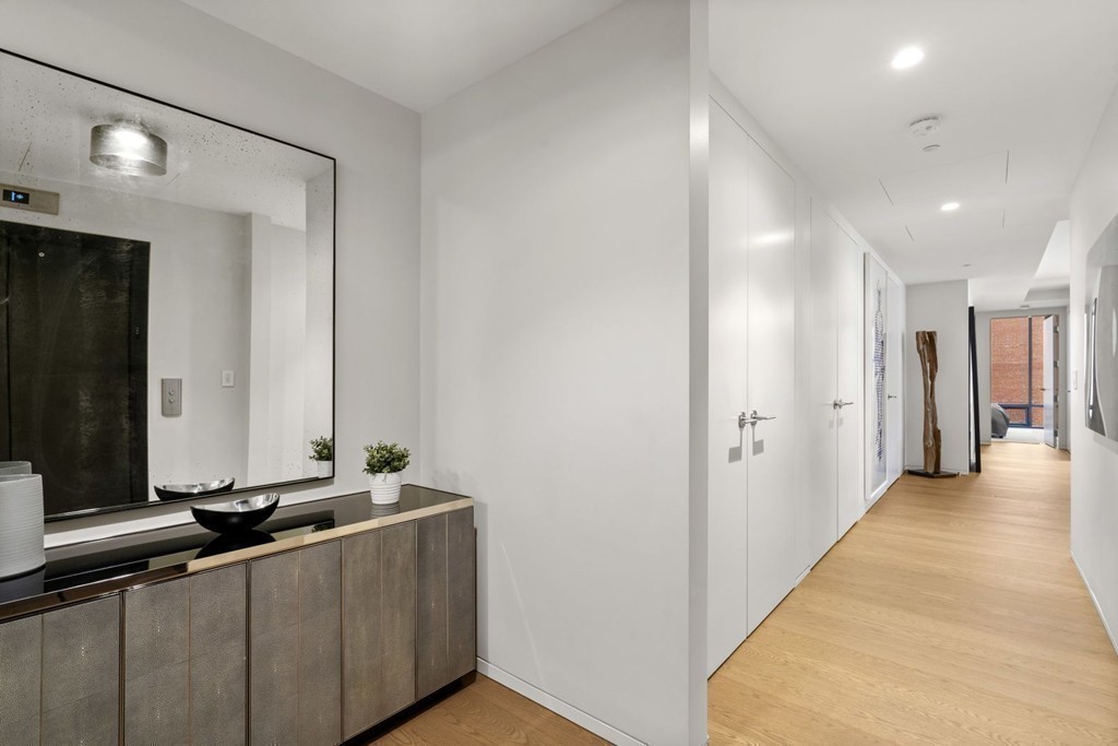 10 Farnsworth Street, Unit 5B Boston, MA 02210 - Photo 27 of 35 a view of a hallway with a large mirror and a sink