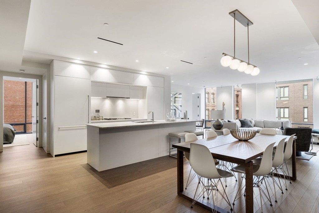 10 Farnsworth Street, Unit 5B Boston, MA 02210 - Photo 3 of 35 a kitchen with a dining table chairs sink and cabinets