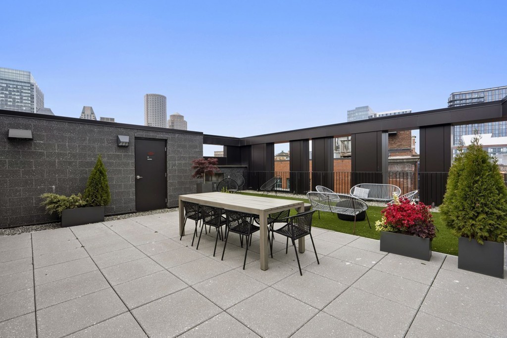 10 Farnsworth Street, Unit 5B Boston, MA 02210 - Photo 31 of 35 a patio with a table and chairs and potted plants