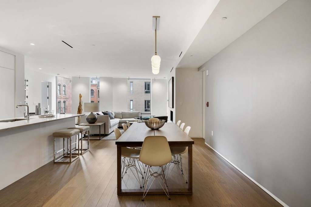 10 Farnsworth Street, Unit 5B Boston, MA 02210 - Photo 7 of 35 a living room with furniture a chandelier and a dining table
