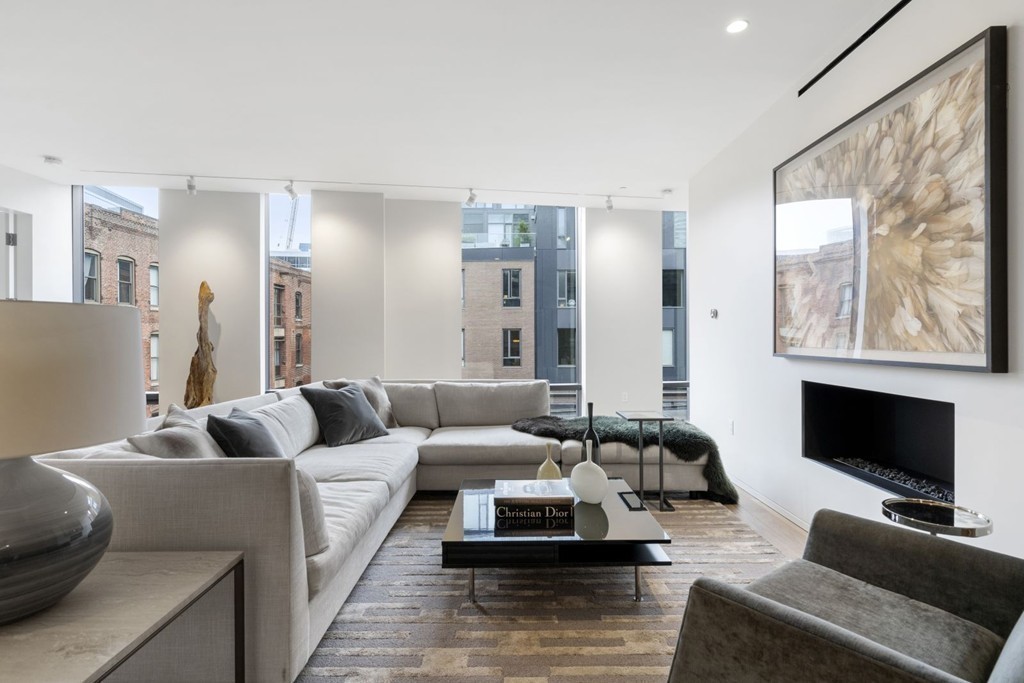 10 Farnsworth Street, Unit 5B Boston, MA 02210 - Photo 8 of 35 a living room with furniture and a flat screen tv