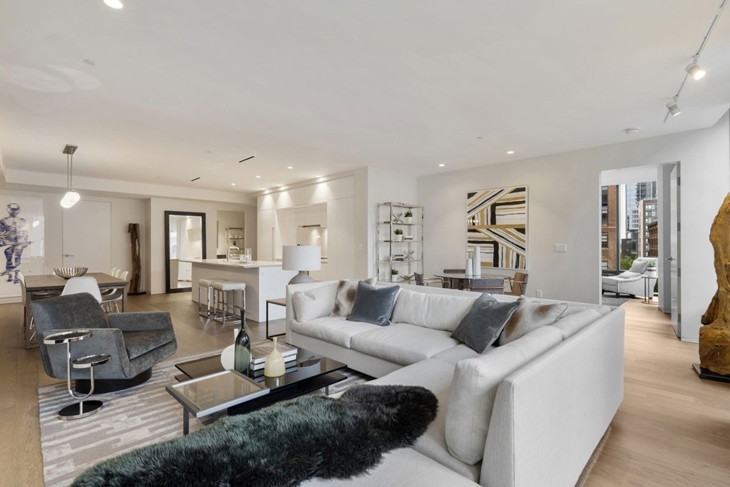 10 Farnsworth Street, Unit 5B Boston, MA 02210 - Photo 10 of 35 a living room with furniture a couch and a dining table