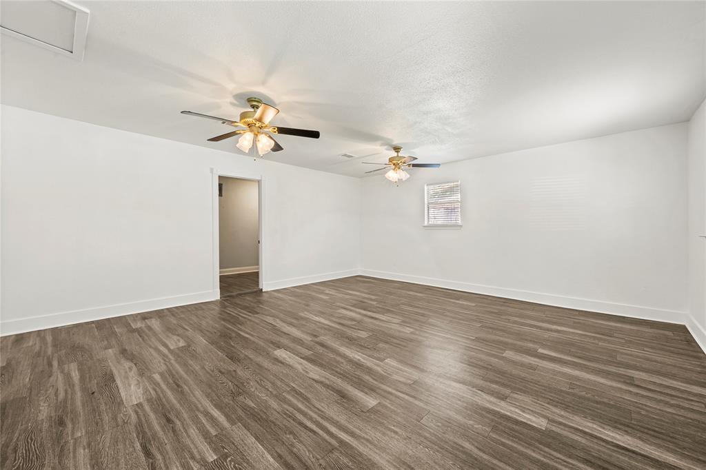 104 East Santa Anna Street Robinson, TX 76706 - Photo 23 of 36 a view of a room with wooden floor and a ceiling fan