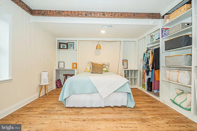 a bedroom with furniture and a book shelf
