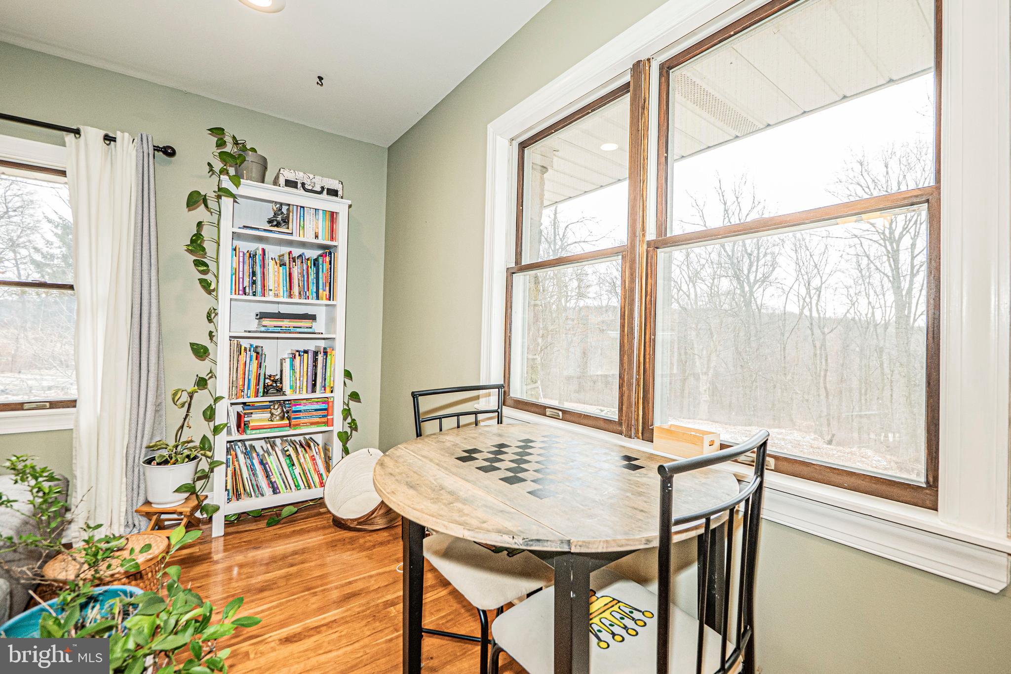 16834 Buck Lantz Road Sabillasville, MD 21780 - Photo 30 of 81 a view of a dining room with furniture and a potted plant