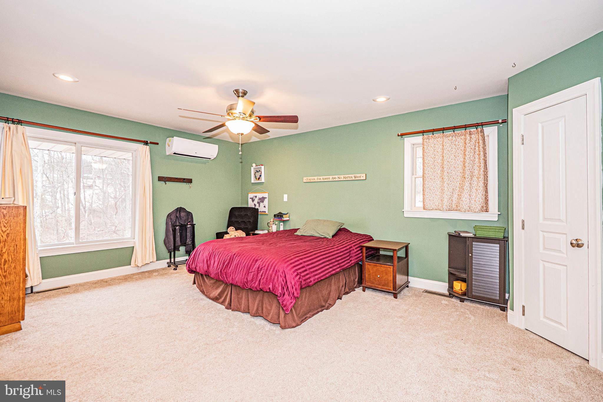 16834 Buck Lantz Road Sabillasville, MD 21780 - Photo 44 of 81 a spacious bedroom with a bed and a chandelier