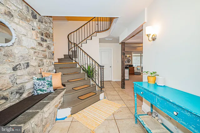 a living room with fireplace furniture and a wooden floor