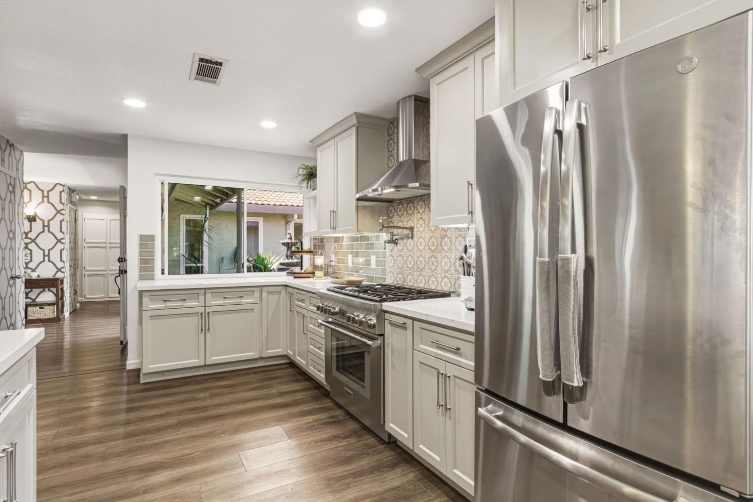 2882 El Camino Real Merced, CA 95340 - Photo 11 of 32 a kitchen with stainless steel appliances a refrigerator sink and cabinets