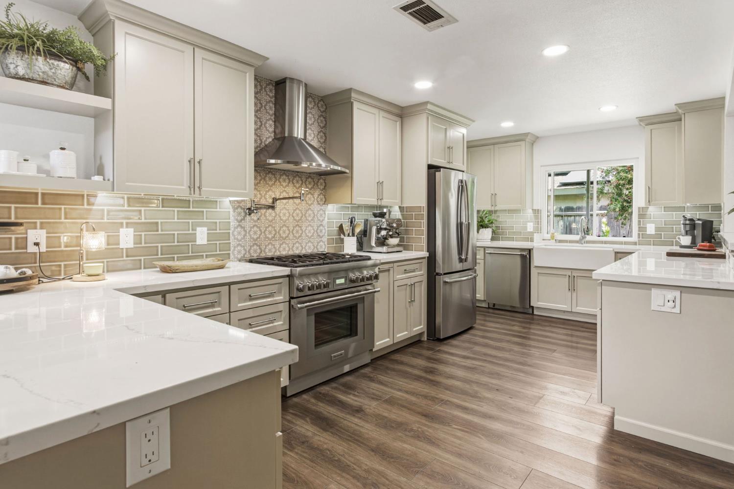 2882 El Camino Real Merced, CA 95340 - Photo 13 of 32 a kitchen with stainless steel appliances a sink a stove a refrigerator cabinets and a counter top space