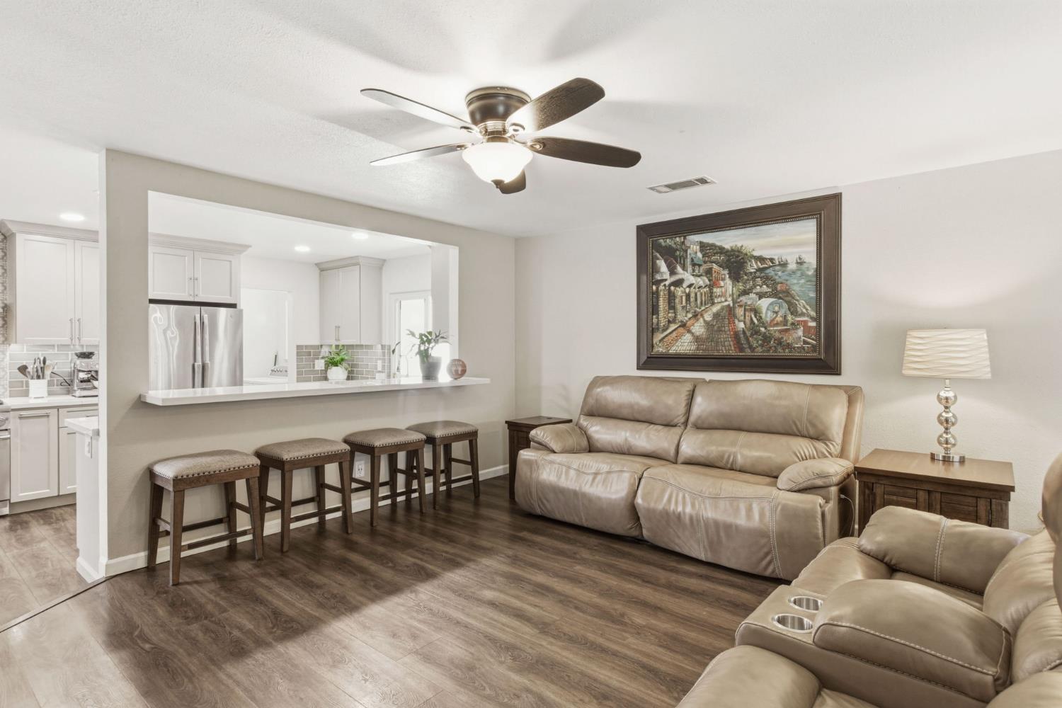 2882 El Camino Real Merced, CA 95340 - Photo 15 of 32 a living room with furniture kitchen view and a wooden floor