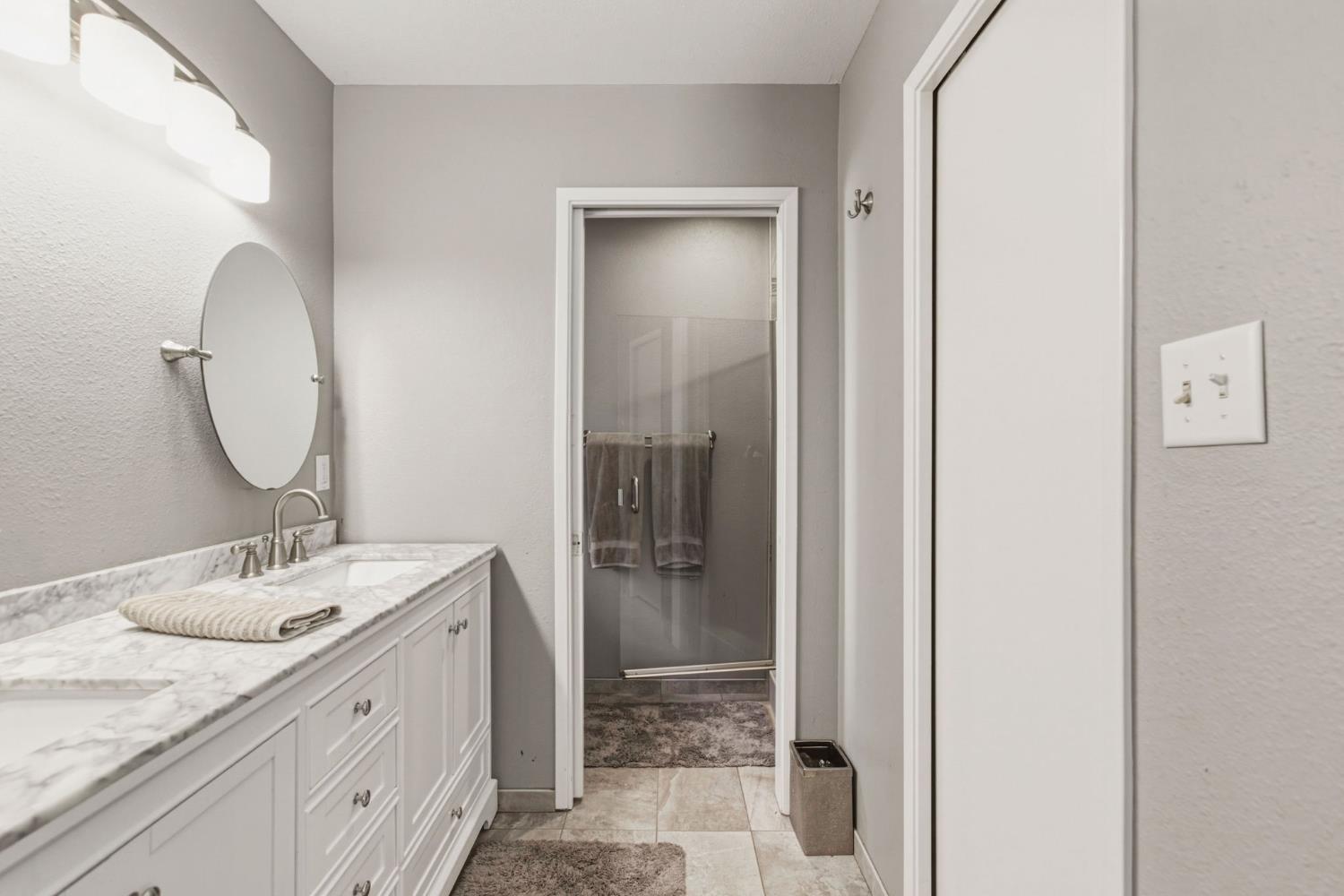 2882 El Camino Real Merced, CA 95340 - Photo 20 of 32 a bathroom with a granite countertop sink mirror and shower