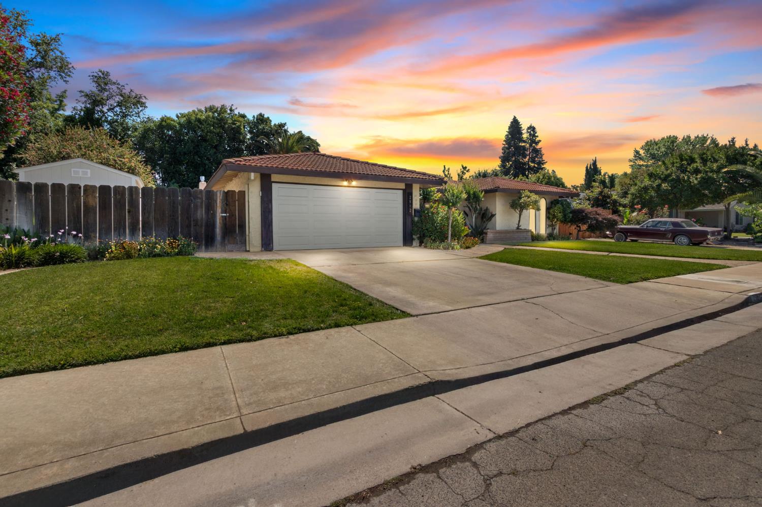 2882 El Camino Real Merced, CA 95340 - Photo 2 of 32 a front view of a house with a yard and garage