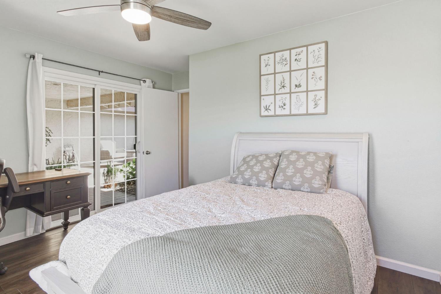 2882 El Camino Real Merced, CA 95340 - Photo 22 of 32 a bedroom with a large bed and a chandelier