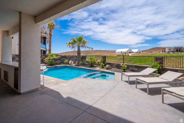 3606 South Cypress Road Hurricane, UT 84737 - Photo 63 of 69 Integrated pool / spa featuring a patio area and a fenced backyard