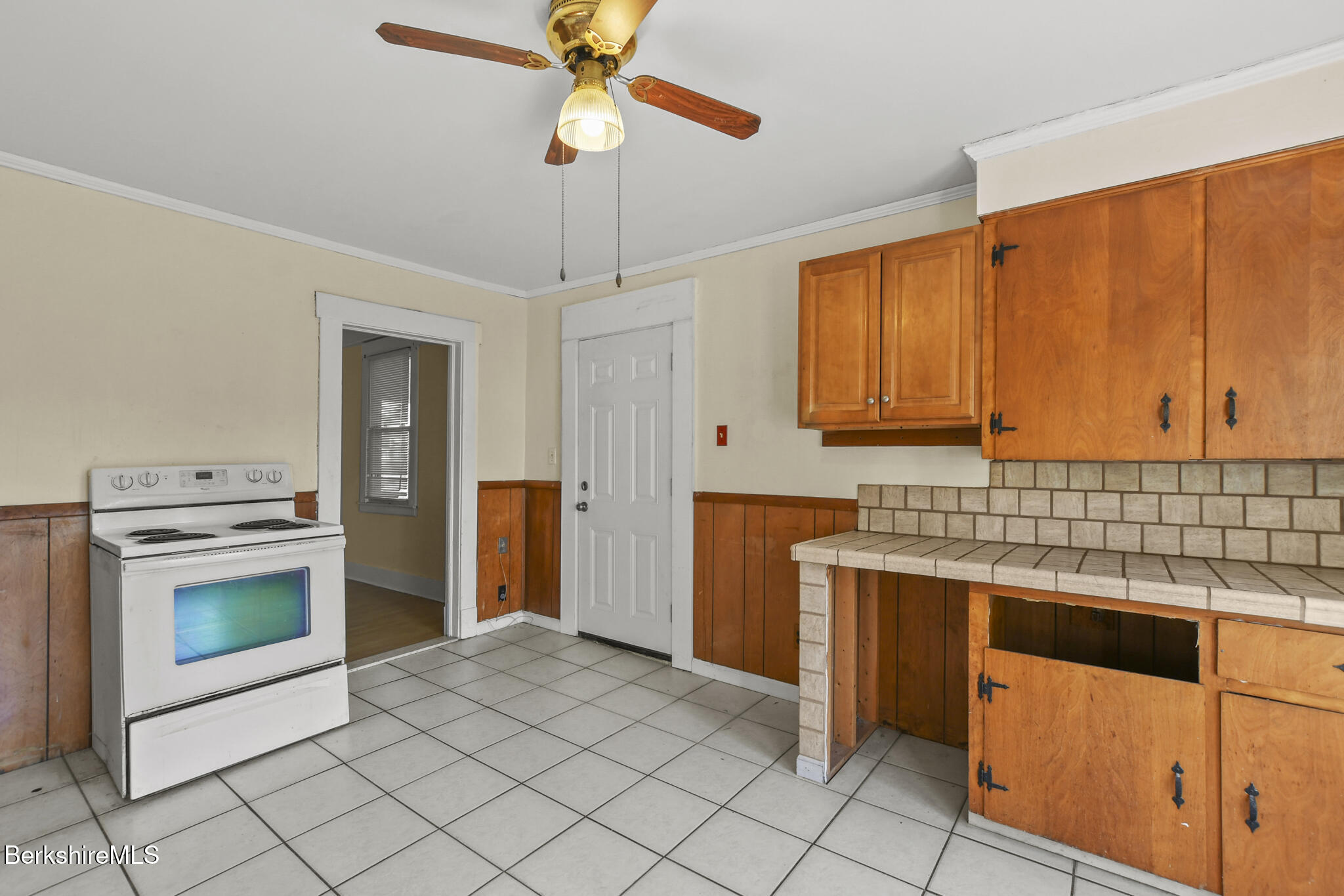 21 Pacific Street Pittsfield, MA 01201 - Photo 14 of 29 a kitchen with stainless steel appliances granite countertop a stove a sink and a refrigerator with wooden cabinets