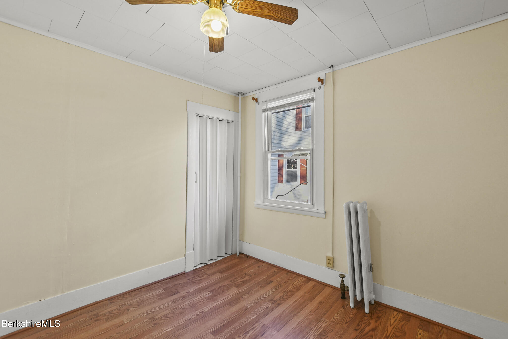 21 Pacific Street Pittsfield, MA 01201 - Photo 16 of 29 an empty room with wooden floor closet and windows