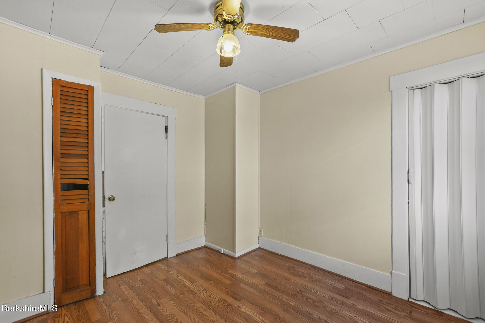 21 Pacific Street Pittsfield, MA 01201 - Photo 17 of 29 an empty room with wooden floor closet and chandelier fan