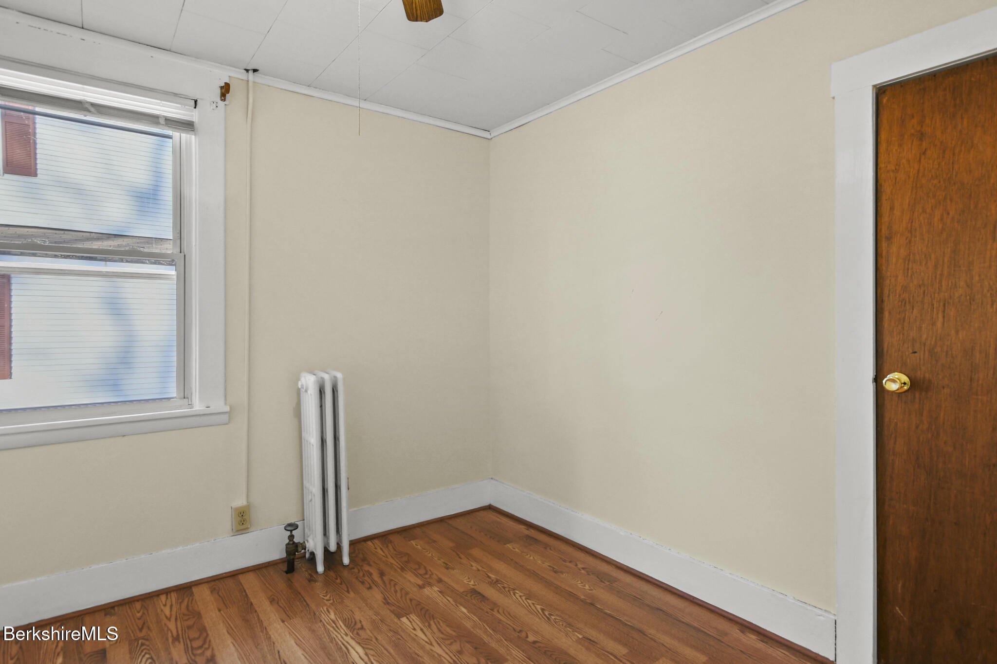 21 Pacific Street Pittsfield, MA 01201 - Photo 18 of 29 a view of an empty room with wooden floor and a window
