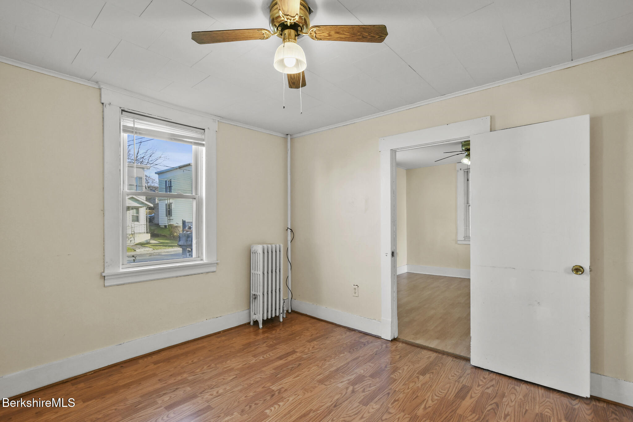 21 Pacific Street Pittsfield, MA 01201 - Photo 21 of 29 a view of an empty room with wooden floor and a window