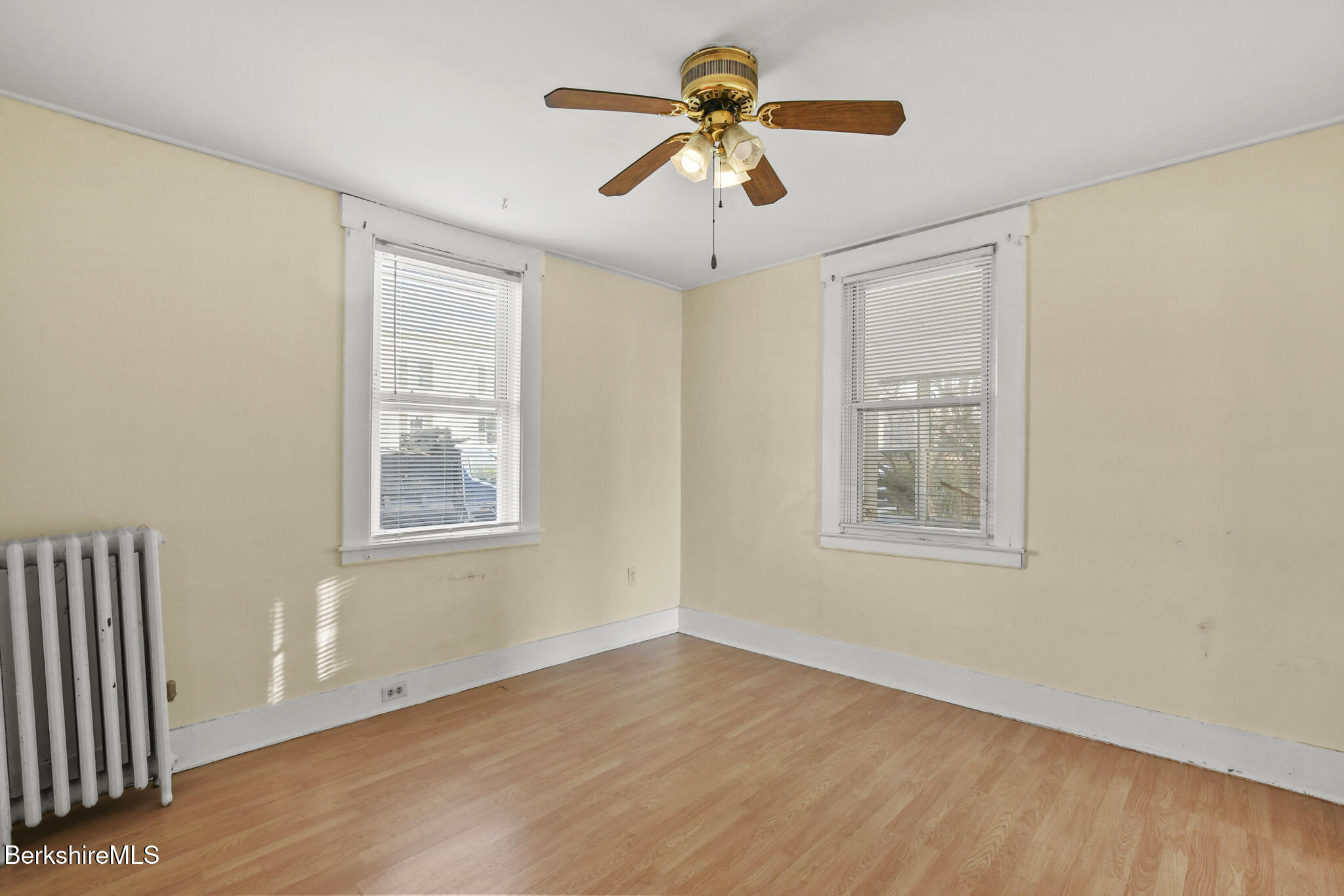 21 Pacific Street Pittsfield, MA 01201 - Photo 24 of 29 a view of an empty room with a window and wooden floor