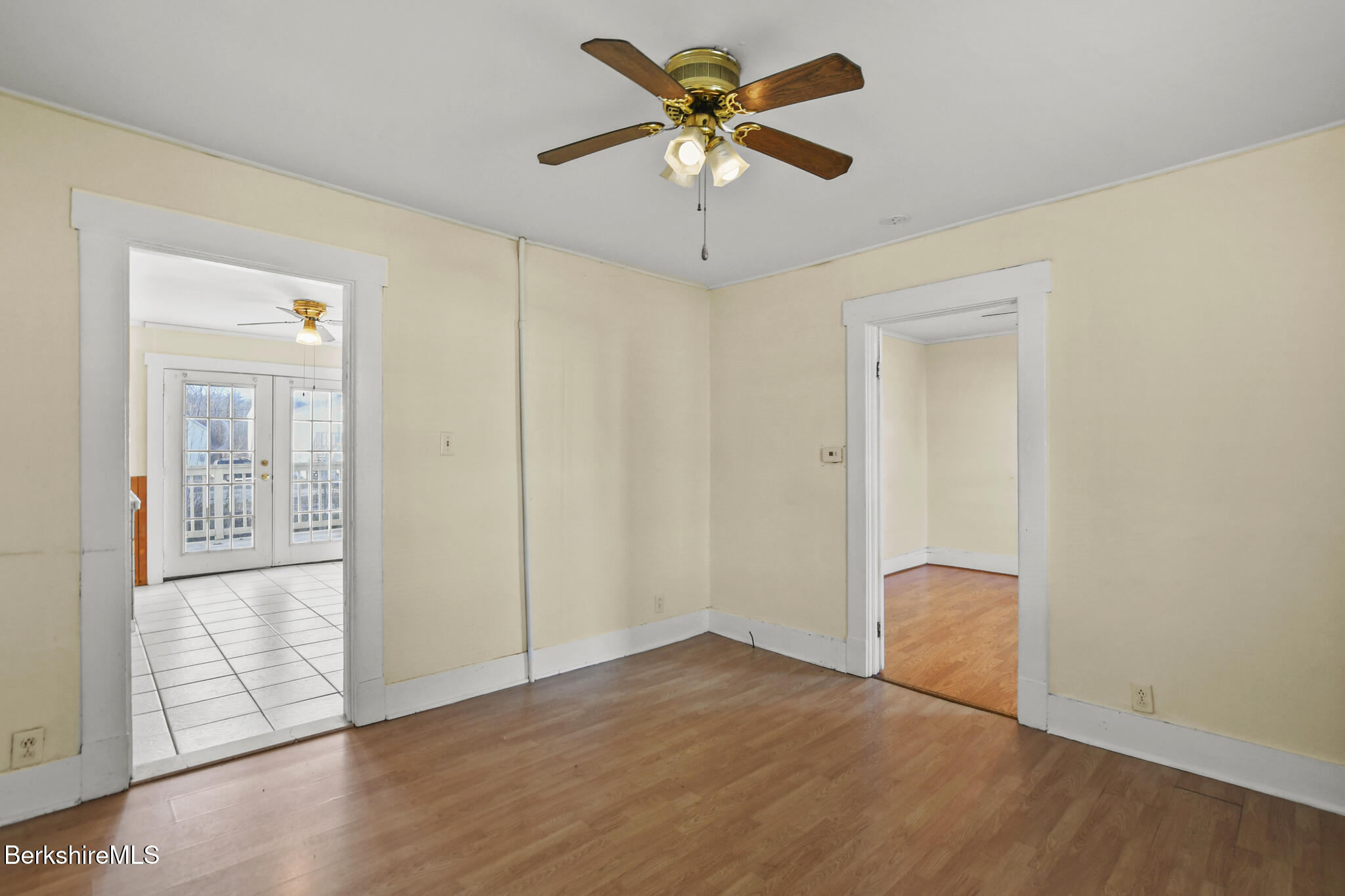 21 Pacific Street Pittsfield, MA 01201 - Photo 26 of 29 an empty room with wooden floor and a ceiling fan