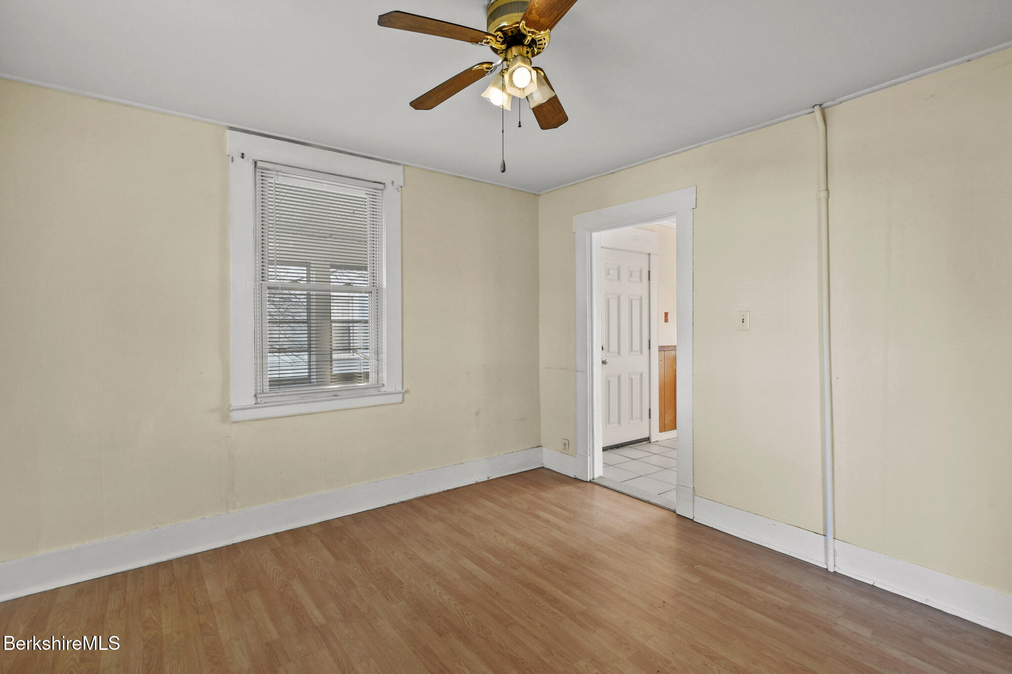 21 Pacific Street Pittsfield, MA 01201 - Photo 27 of 29 an empty room with wooden floor chandelier fan and windows