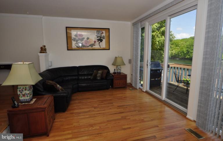 2013 Chadds Ford Drive Reston, VA 20191 - Photo 17 of 24 The living room leads to the main level deck.
