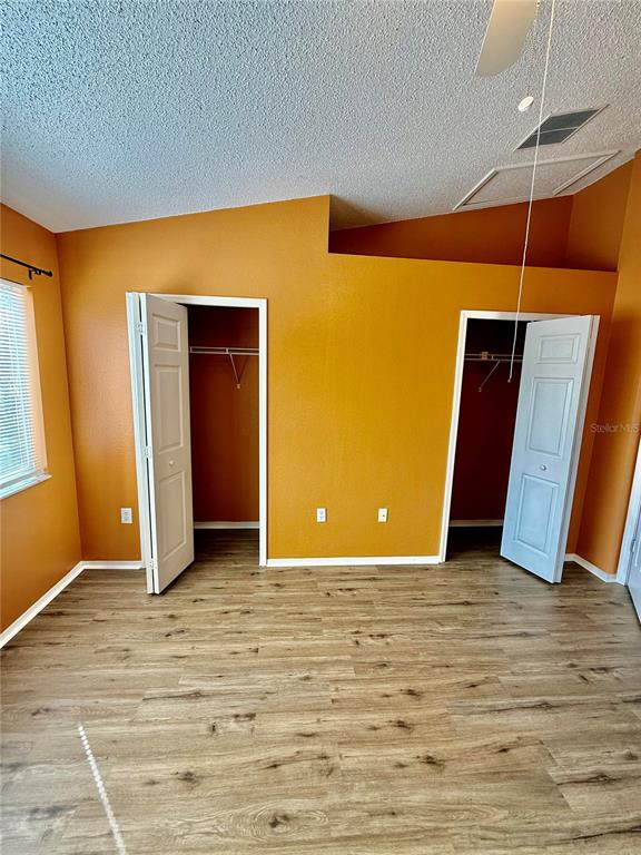 29920 Playa Del Rey Lane Wesley Chapel, FL 33543 - Photo 13 of 32 a view of a room with wooden floor