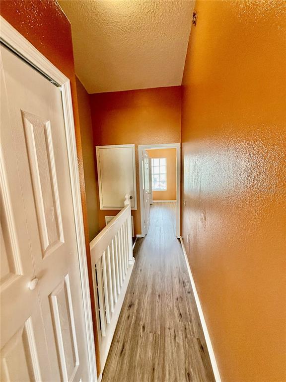 29920 Playa Del Rey Lane Wesley Chapel, FL 33543 - Photo 14 of 32 a view of a hallway with wooden floor and staircase
