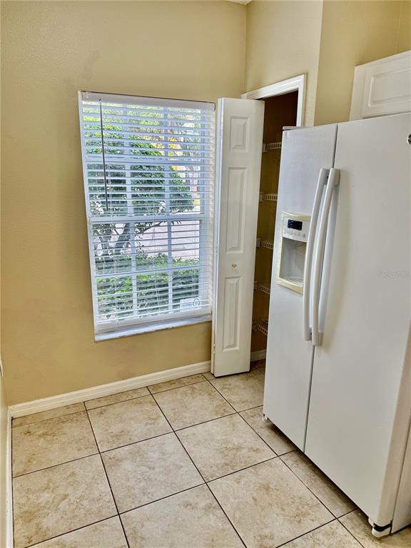 29920 Playa Del Rey Lane Wesley Chapel, FL 33543 - Photo 22 of 32 a view of a refrigerator in kitchen and an empty room