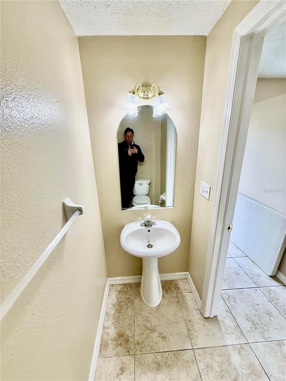 29920 Playa Del Rey Lane Wesley Chapel, FL 33543 - Photo 23 of 32 a bathroom with a sink a toilet and mirror