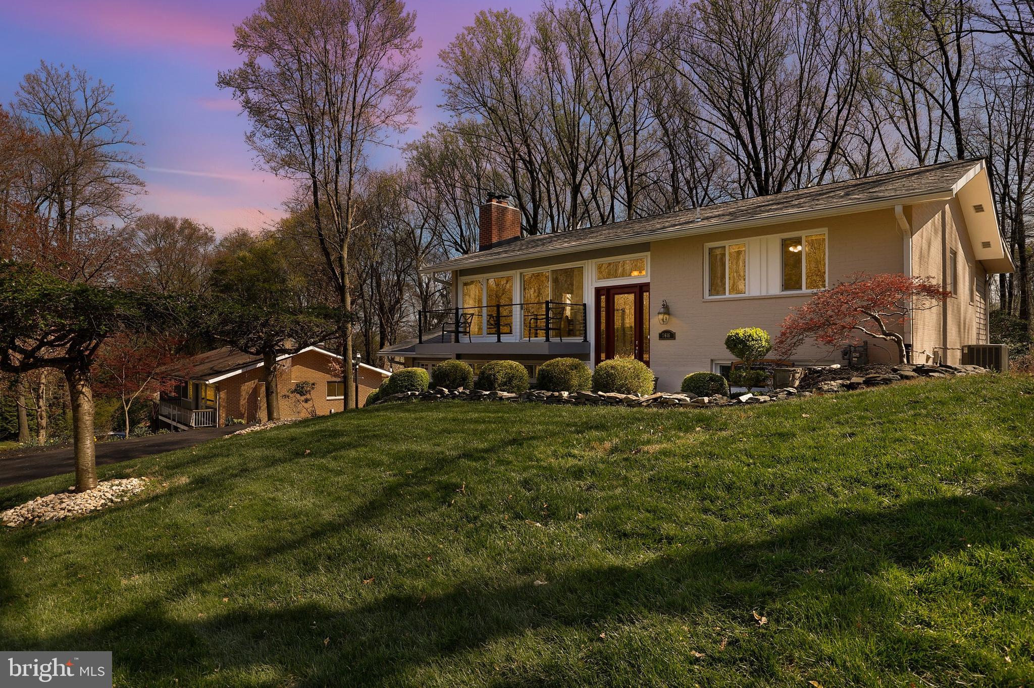 7616 Hamilton Spring Road Bethesda, MD 20817 - Photo 1 of 64 a front view of a house with garden