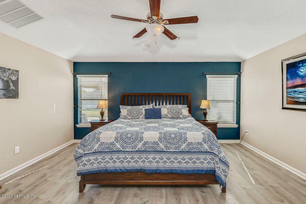 1737 North Cappero Drive St. Augustine, FL 32092 - Photo 18 of 47 a bedroom with a bed and a chandelier