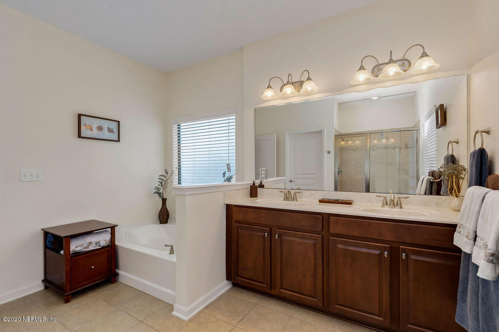 1737 North Cappero Drive St. Augustine, FL 32092 - Photo 21 of 47 a spacious bathroom with a double vanity sink mirror and bathtub