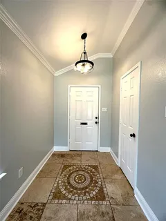 a view of a hallway with a chandelier